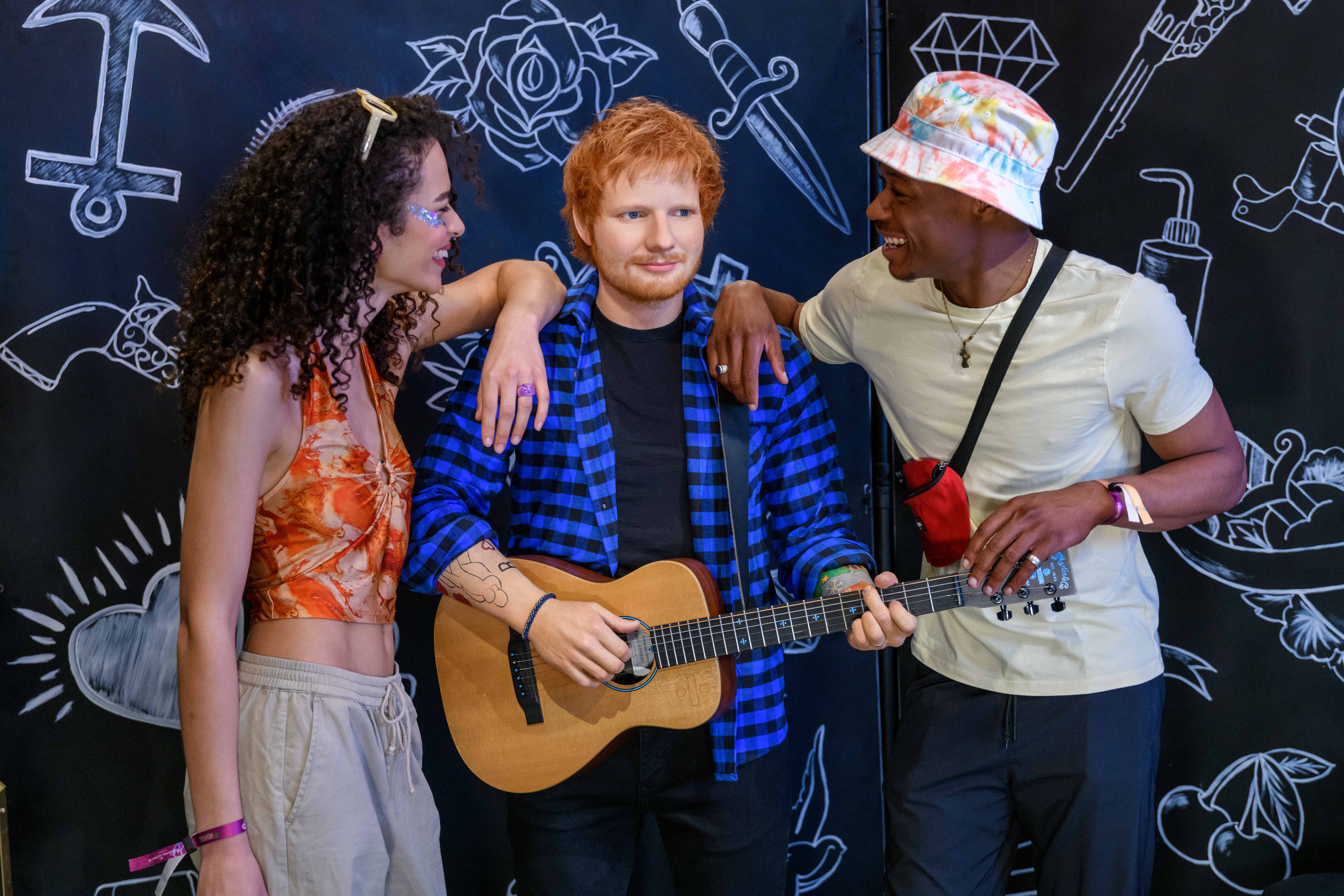 Couple enjoying Ed Sheeran figure at Madame Tussauds 